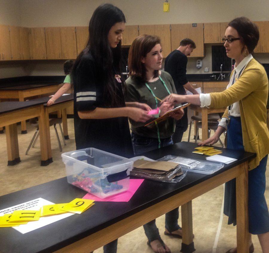 Stephanie Chronister helping seniors Rebecca Sollars and Allison Ingram on their project.