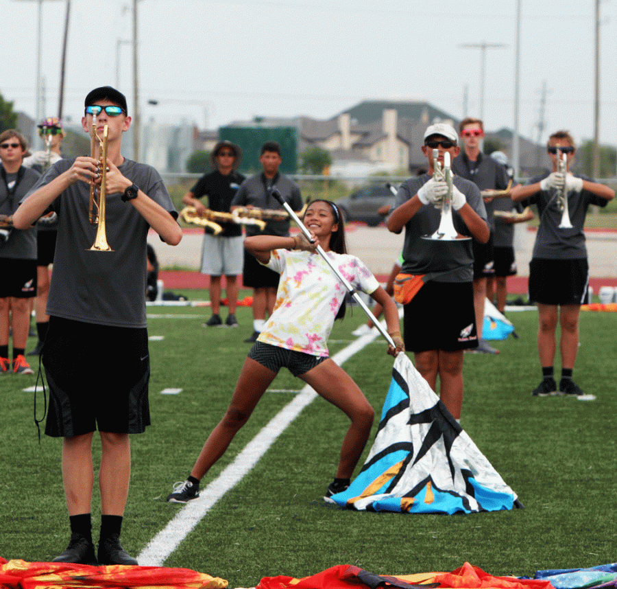 Junior Sharla Cimbak practicing the half time performance with the band.
