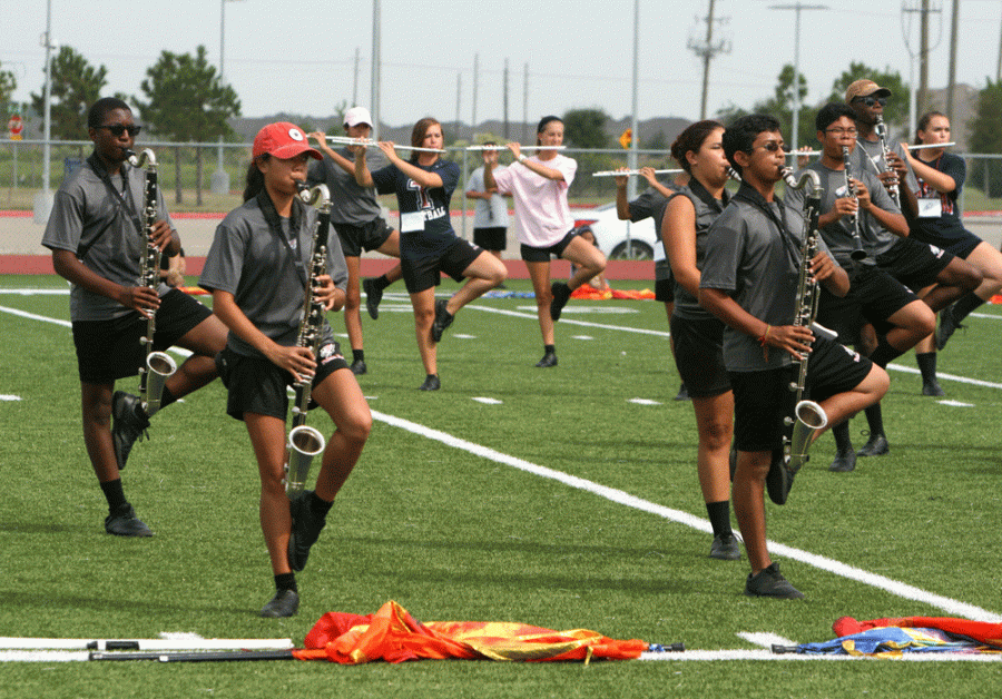 Sophmore Reagan Shemon in the black shirt playing her flute at marching practice.