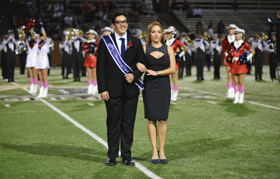 Senior+Leo+Garcia%2C+escorted+by+his+mother+during+the+homecoming+King+and+Queen+announcements.