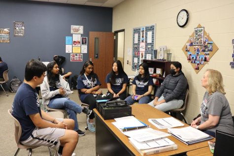 FBLA meets together, with their sponsor, to discuss future project plans. Their goal is to provide access to goods for those in need.