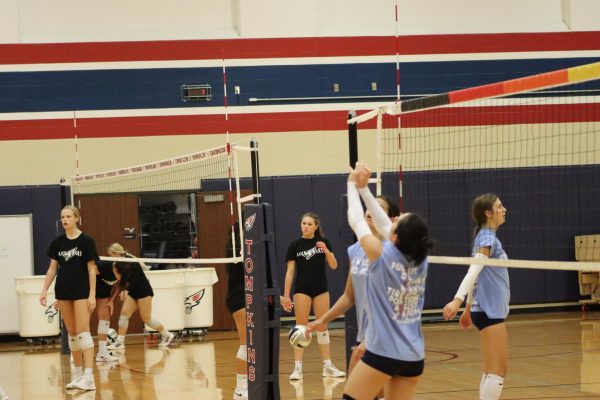 Varsity volleyball practices their underhand and overhand serves. The team won 3-2 in a heated match against their top competition, Seven Lakes.