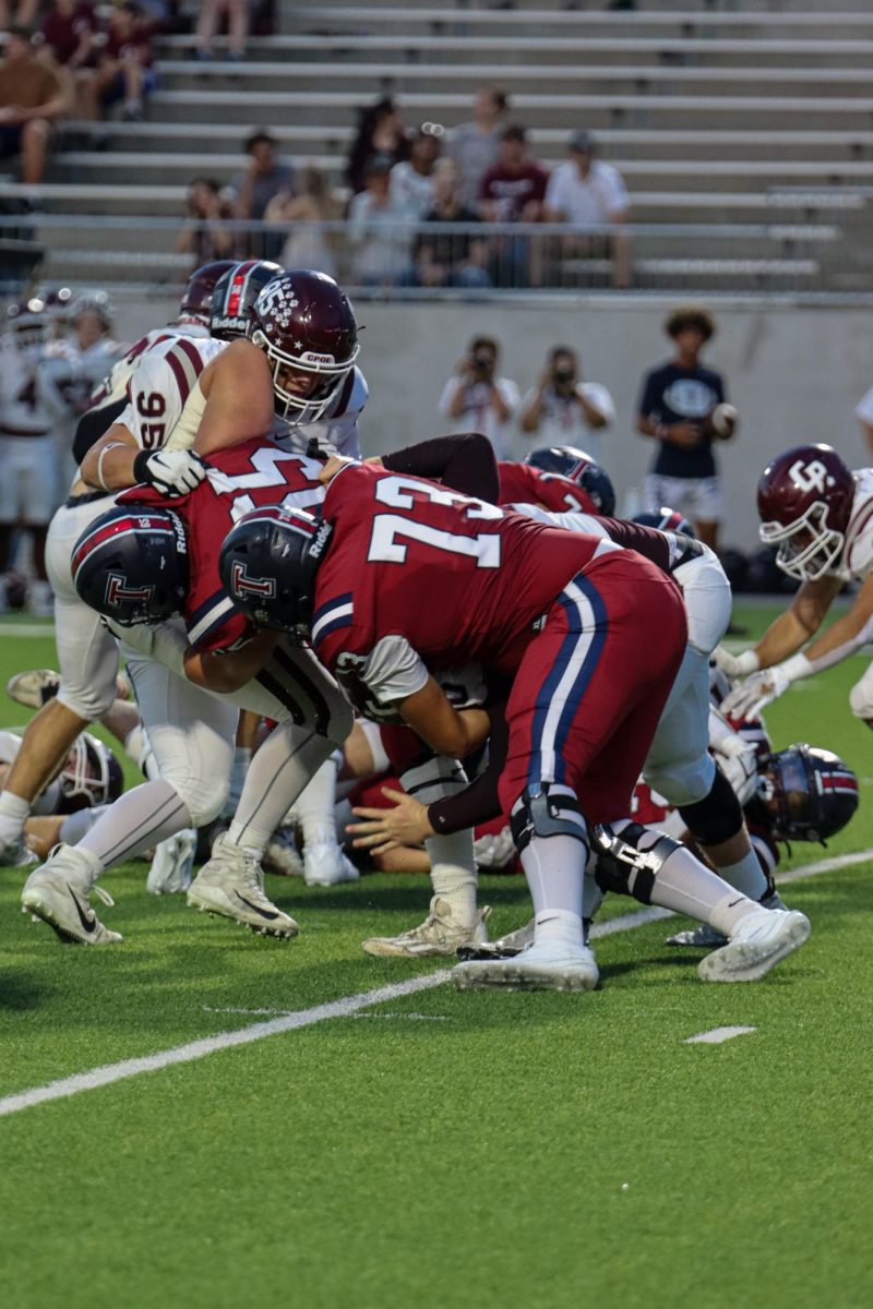Varsity+tackles+Bridgeland+in+a+head+to+head+game.+Despite+their+loss%2C+the+team+continues+to+push+through.