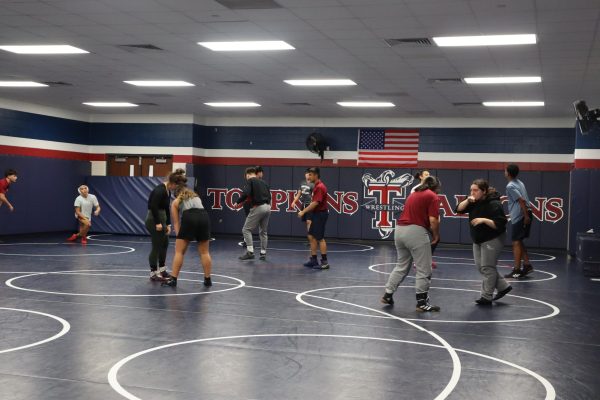 The wrestling team is working their approaches to tackling during practice. The team is focusing on becoming stronger both individually and together.