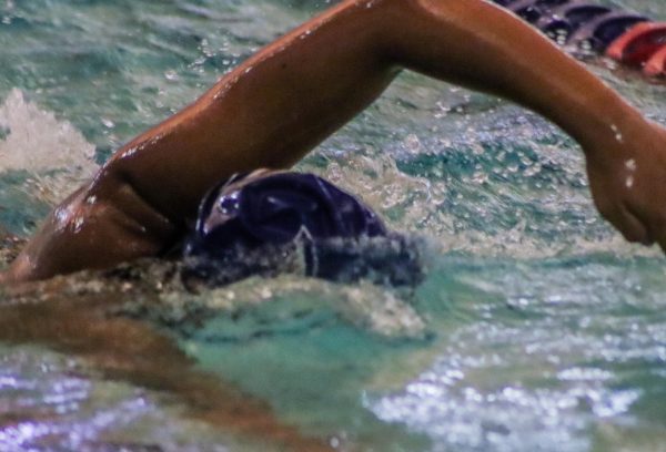 A swimmer on the varsity swim team laps the pool during practice. The team hopes to grow their swimming skills in their practice sessions in order to continue their successful season. 
