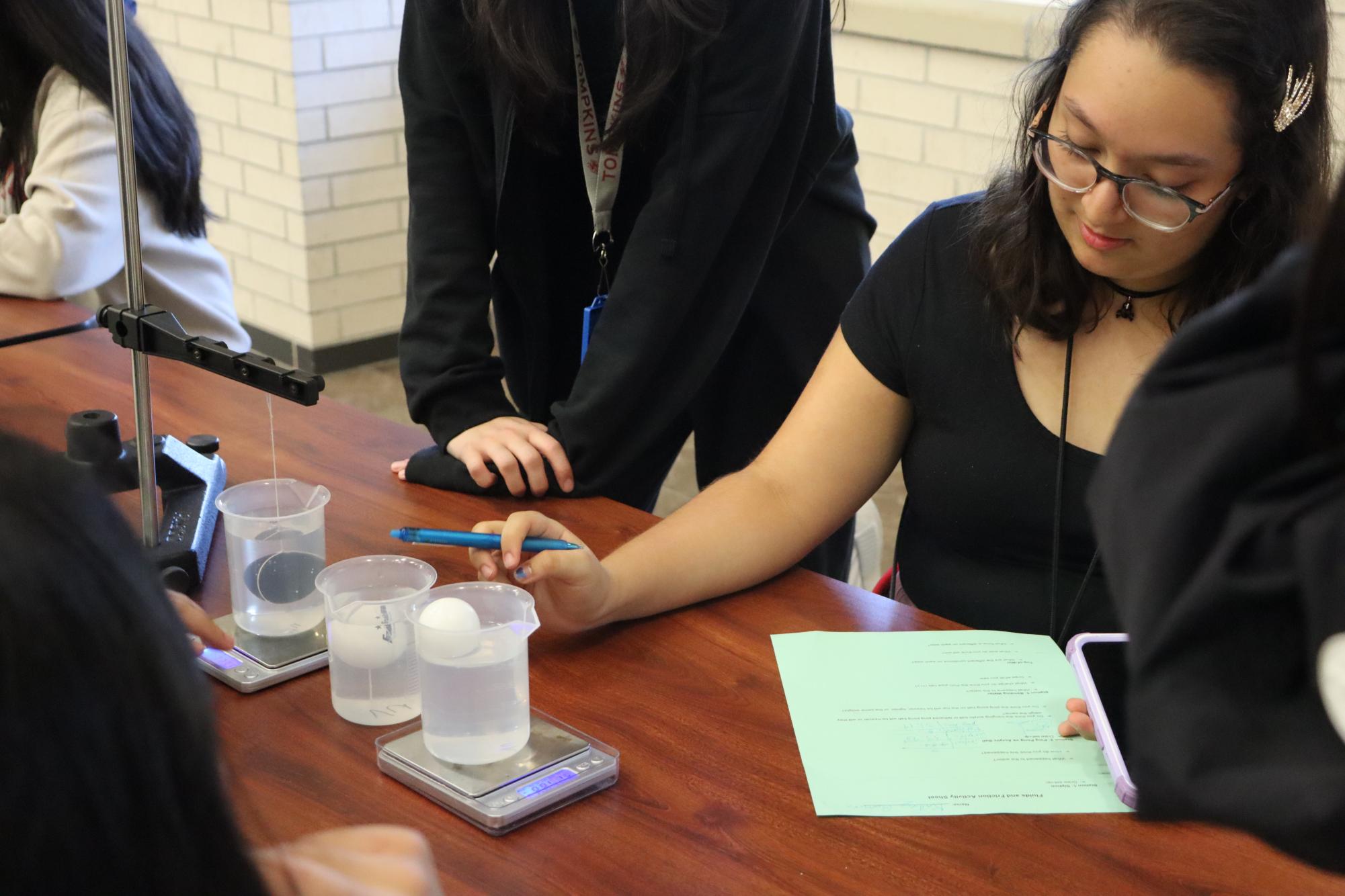 Girls in S.T.E.M member diligently focuses on the egg in beaker, studying its effects. Girls in S.T.E.M put an emphasis on empower girls that want to pursue a career in the S.T.E.M field. 