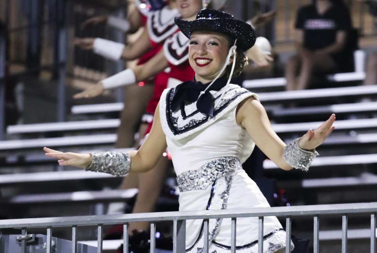 Emma Parnell dances alongside the Cavellettes at the Tompkins vs Paetow game.